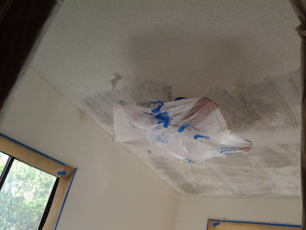 showing a ceiling during the Popcorn Ceiling scraping process.