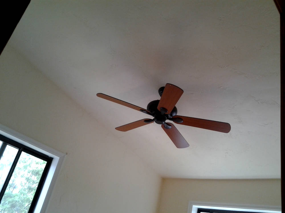 showing a bedroom where the walls and ceilings look freshly textured, primed and painted, like new.