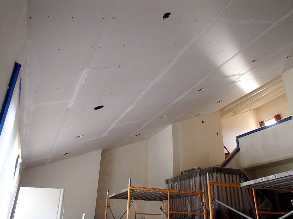 Showing a suspended ceiling with drywall installation done