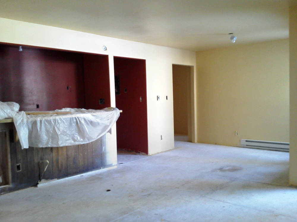 showing a condominium after the wallpaper removal, hand drywall texture, primer and paint are done.