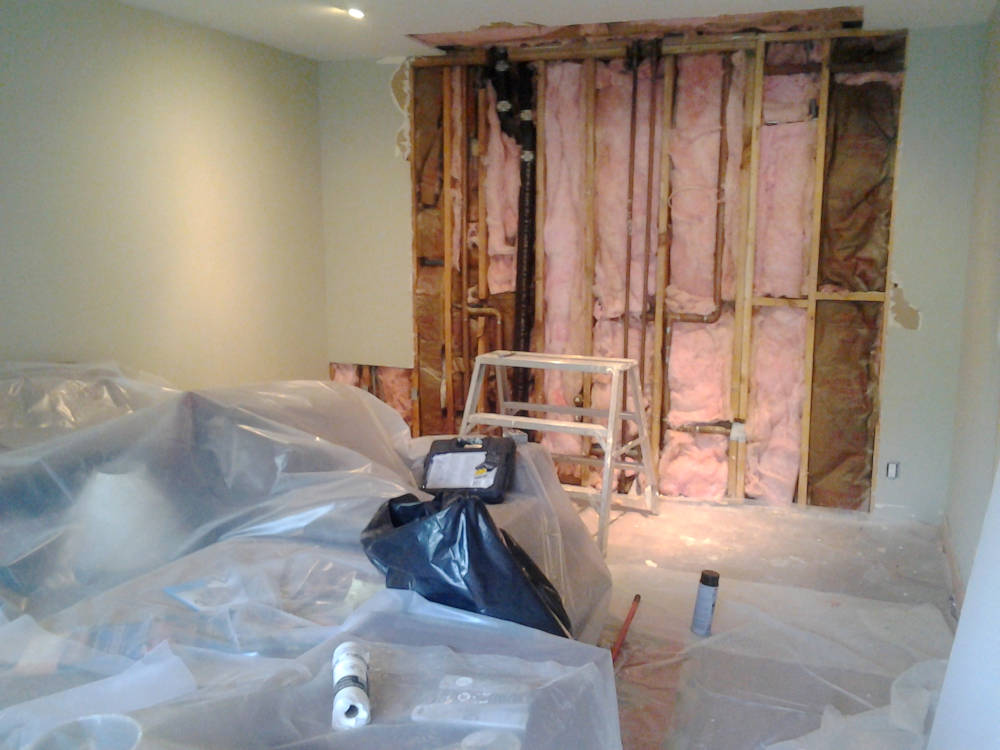 showing a wall with new insulation installed.