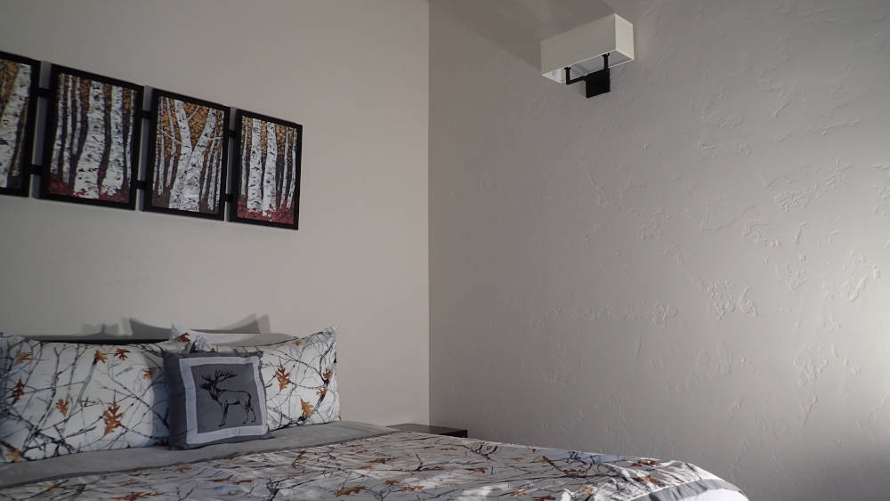 bedroom with the walls showing a drywall skip trowel texture