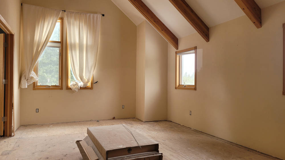 showing a big room where the bottom of the walls have being repaired after water damage.