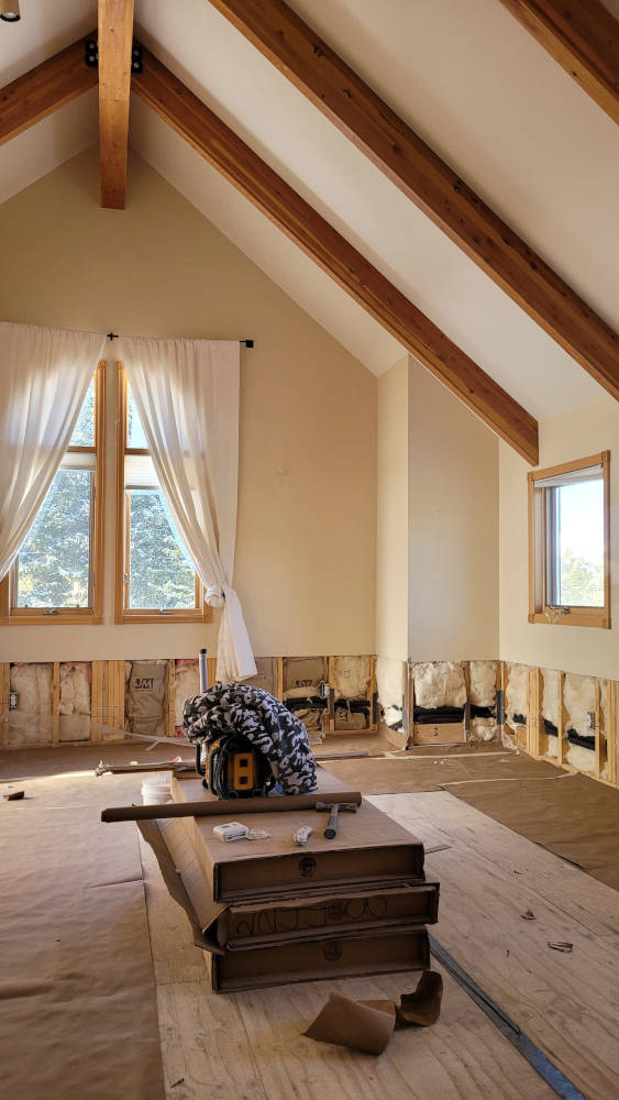 showing a big tall room with the drywall missing at the bottom due to water damage