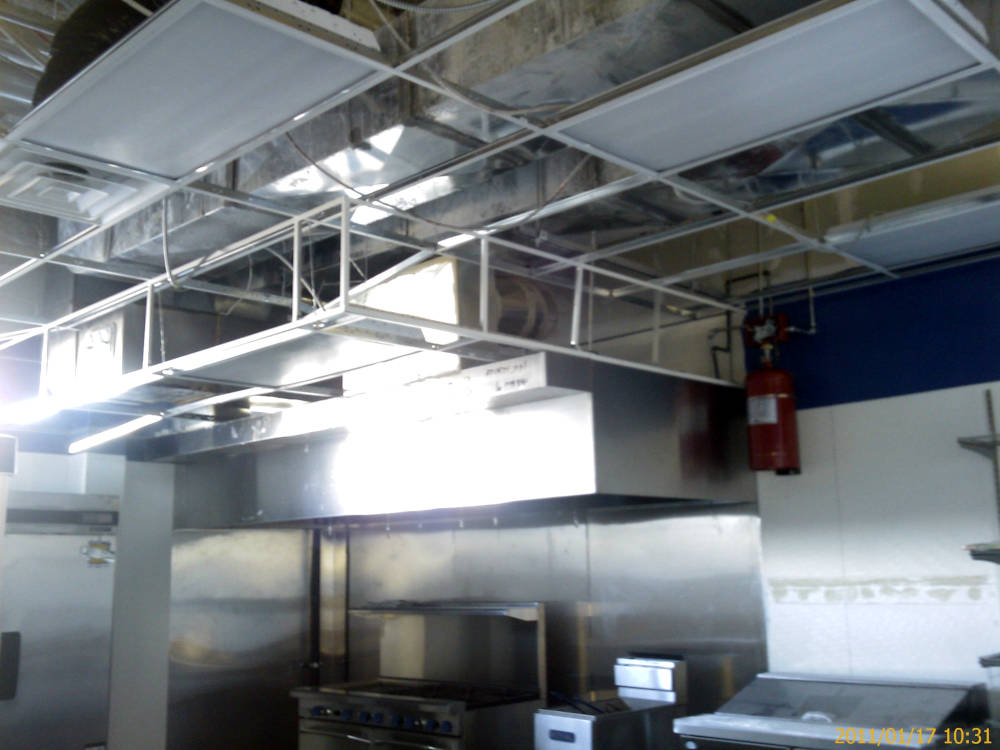 a kitchen in a restaurant showing the acoustical
ceiling after installation.