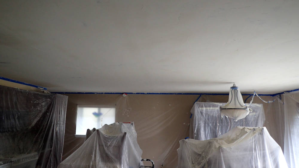 leaving room in Dillon, Colorado covered with plastic to protect it during the popcorn ceiling removal