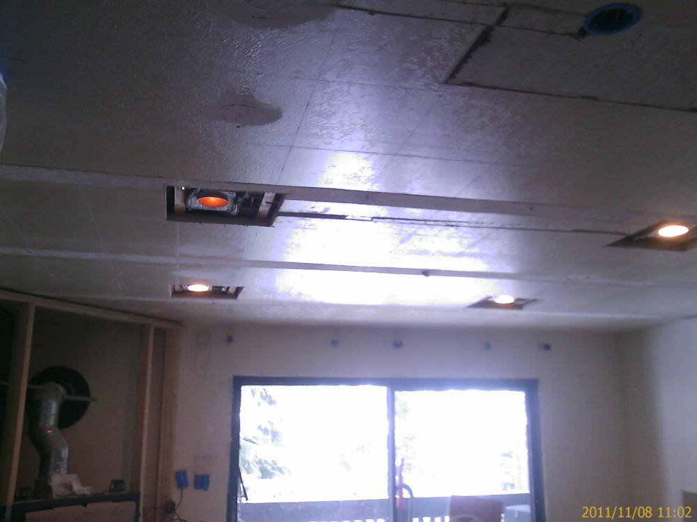 showing a remodel, fixing the drywall patches
because they installed different lights on the ceiling