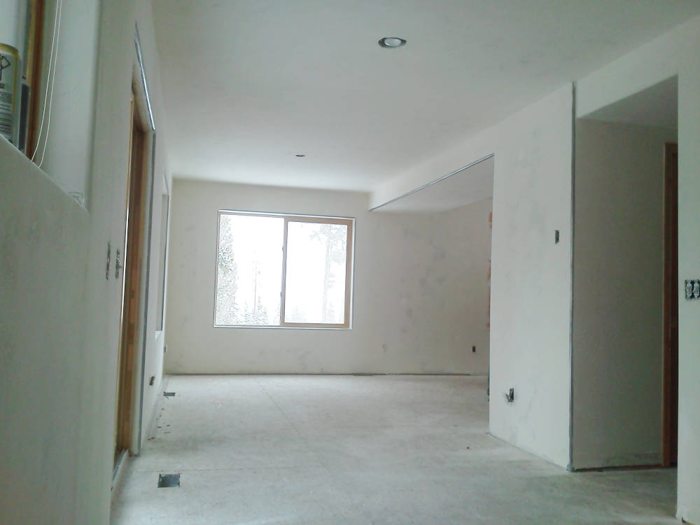 A house with new drywall installation, tape and texture done ready for primer and paint.