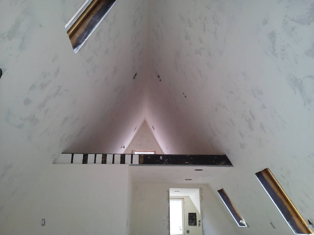 A house with new drywall installation, tape and texture done ready for primer and paint.