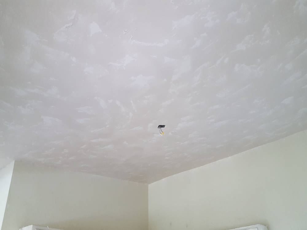 showing a ceiling after the skim coat and skip trowel texture is done, ready for primer and paint.
