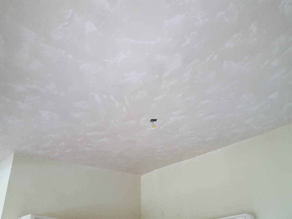 showing a ceiling after the skim coat and skip trowel texture is done, ready for primer and paint.