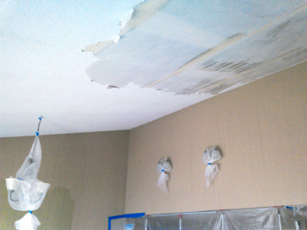 showing popcorn removal being done in a condominium