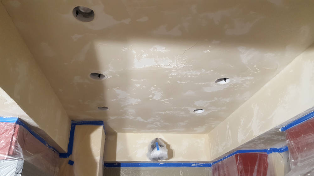 kitchen ceiling during a texture change from a crows feet to a skip trowel drywall texture