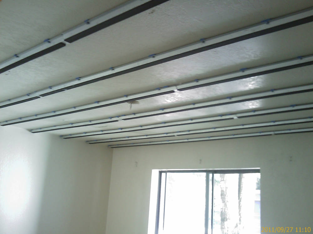 a remodel, texture change from knock down
to skip trowel/hand texture and installation of iso trax in the ceiling for better sound control