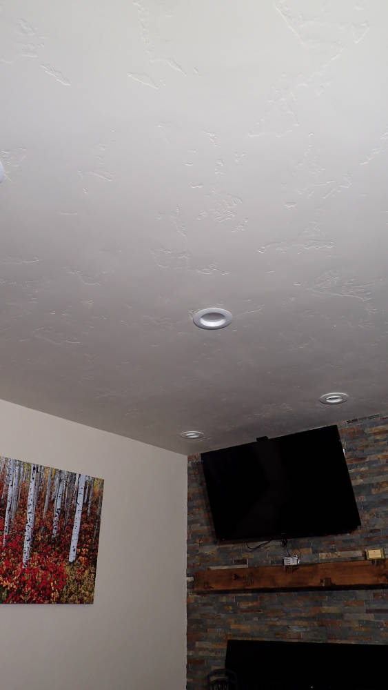 Leaving room area that used to have an orange peel drywall texture showing a brand new skip trowel drywall texture.