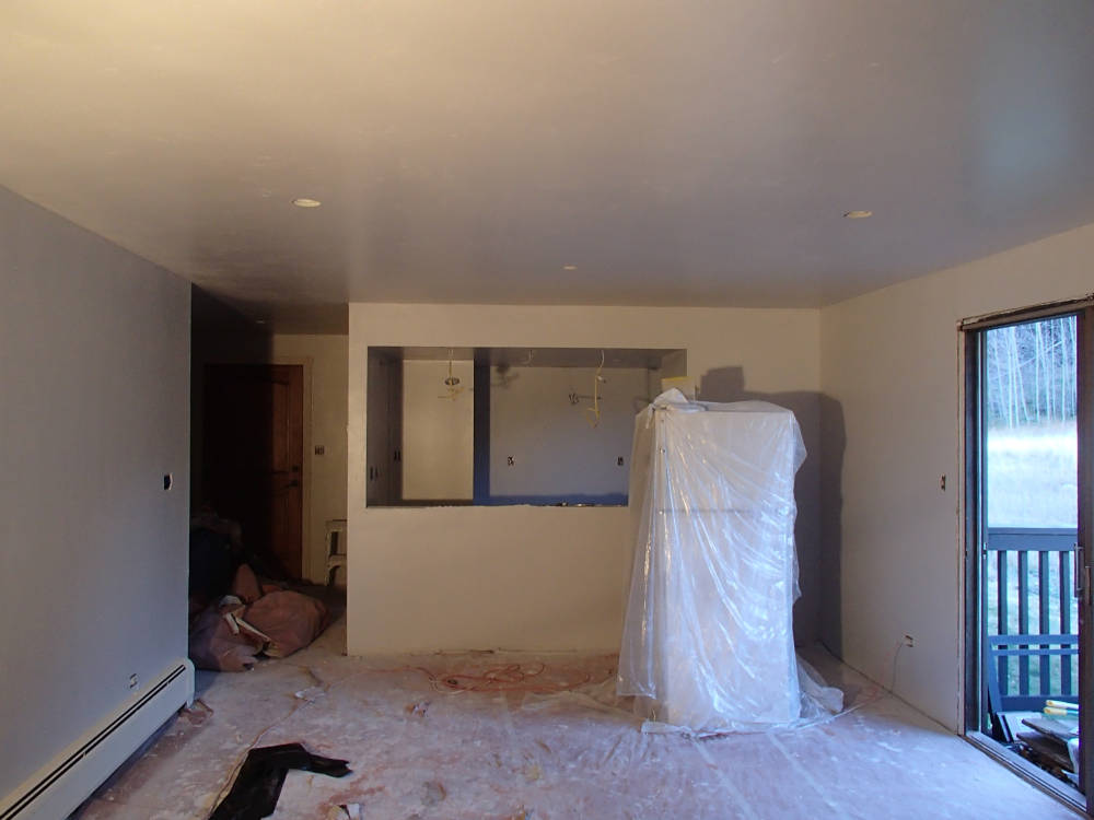 After the new drywall was installed on top of the popcorn ceiling, taped, textured, primed and painted.
