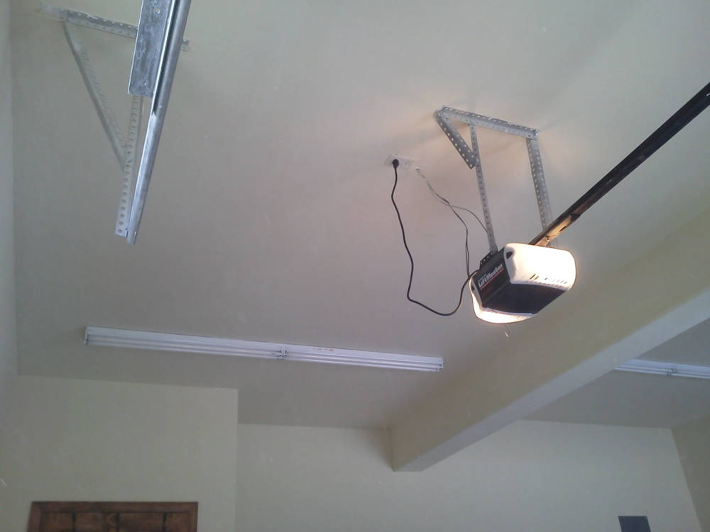 A garage with water damage repair done, primed and painted.