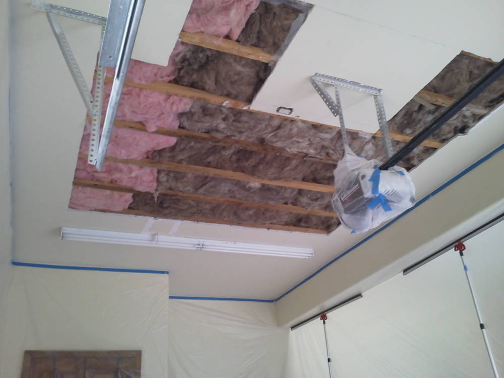 garage ceiling with water damage from a leak from the floor above it.